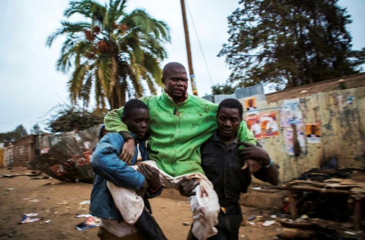 Un homme blessé est transporté dans le bidonville de Kibera à Nairobi, le 12 août 2017