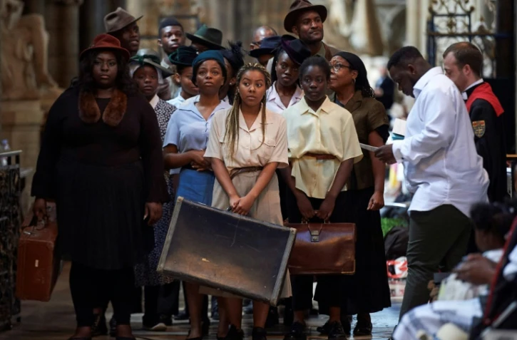 A l'abbaye de Westminster à Londres le 22 juin 2018, des comédiens participent aux commémorations de l'arrivée du navire Empire Windrush au port de Tilbury, il y a 70 ans