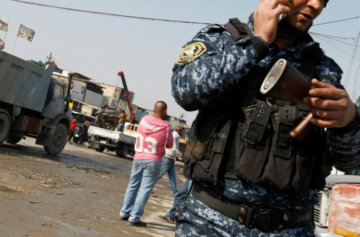 Un policier irakien après l'explosion d'un véhicule piégé à Bagdad, le 14 février 2017