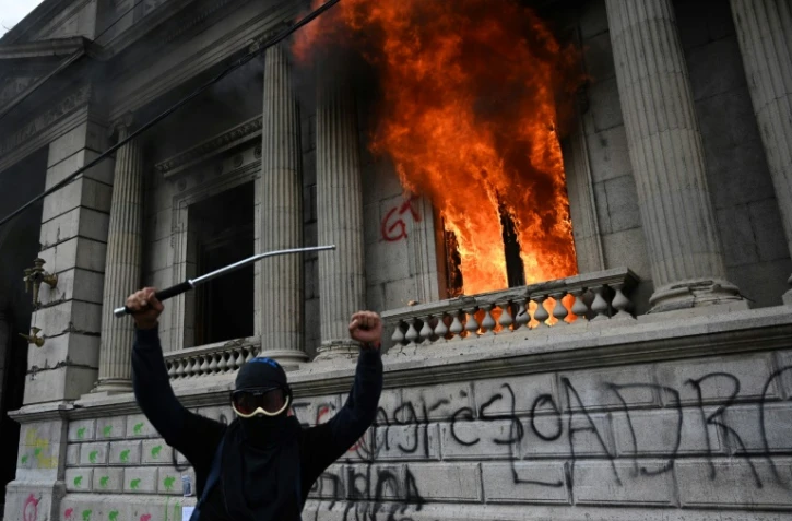 Un manifestant devant le Congrès en feu dans la ville de Guatemala le 21 novembre 2020