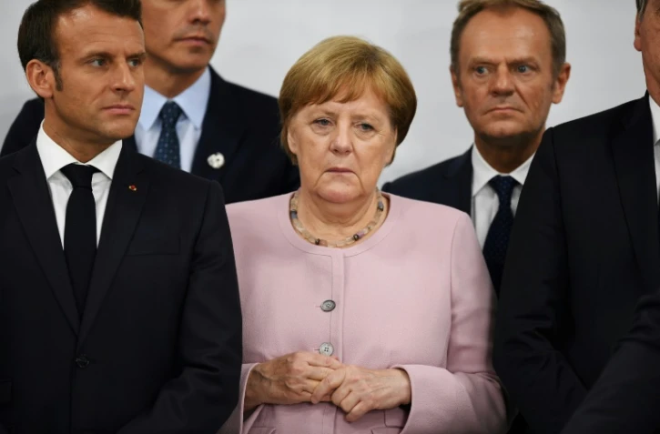 Le président français Emmanuel Macron, la chancelière allemande Angela Merkel et le président du conseil Donald Tusk lors du sommet du G20 à Osaka le 29 juin 2019