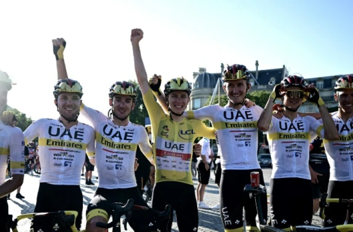 Le Slovène Tadej Pogacar (c) fête sa victoire au Tour de France avec ses équipiers à l'issue de la 21e et dernière étape, entre Chatou et Paris, le 18 juillet 2021
