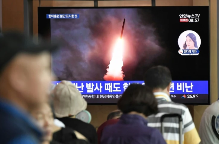 Des Sud-Coréens devant un écran de télévision diffusant des images du lancement d'un missile nord-coréen, à la gare de Séoul le 10 août 2019