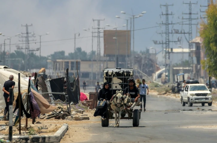 Des Palestiniens sur une charrette tirée par un âne, sur la route Salaheddine, à Deir el-Balah, dans le centre de la bande de Gaza, le 21 juillet 2025