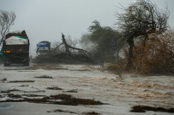 Des arbres arrachés, une route inondées, après le passage du cyclone Tauktae, le 18 mai 2021 près de Diu, en Inde