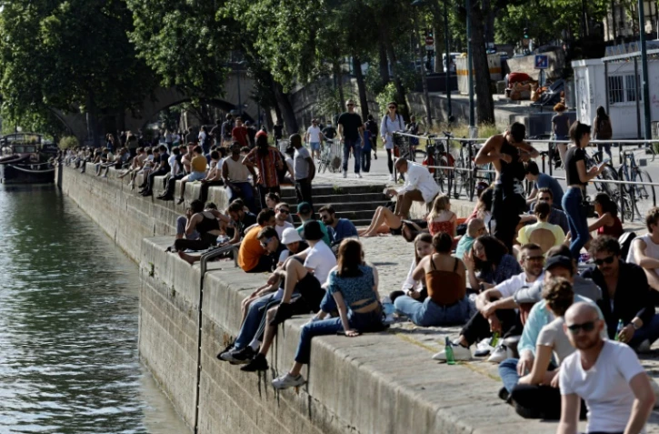 Des Parisiens prennent le soleil sur les berges de la Seine, le 19 mai 2020