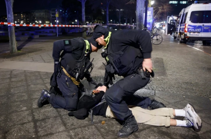 Des policiers arrêtent un suspect après qu'une personne a été poignardée près du Mémorial de l'Holocauste à Berlin, le 21 février 2025