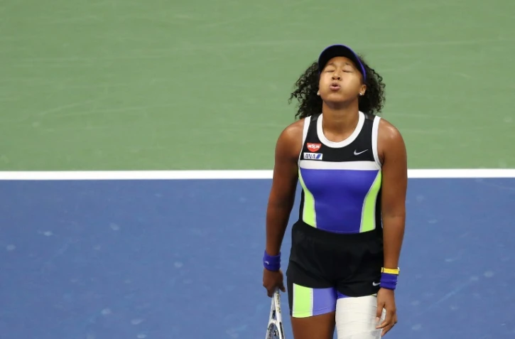 La Japonaise Naomi Osaka soupire après son point gagnant qui lui donne le titre de l'US Open après la finale disputée contre la Bélarusse Victoria Azarenka, le 12 septembre 2020 à Flushing Meadows, New York
