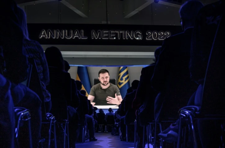 Le président ukrainien Volodymyr Zelensky apparaît sur un écran géant pendant son discours par visioconférence devant le Forum économique mondial de Davos (Suisse), le 23 mai 2022