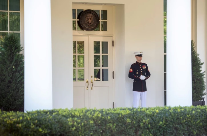 Un membre du corps des Marines assure un tour de garde devant la West Wing, à la Maison Blanche, signe que le président américain Donald Trump se trouve dans le Bureau ovale