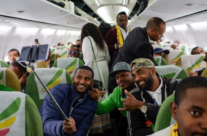 Des passagers posent dans l'avion des Ethiopian Airlines reliant Addis Abeba à Asmara le 18 juillet 2018. 
