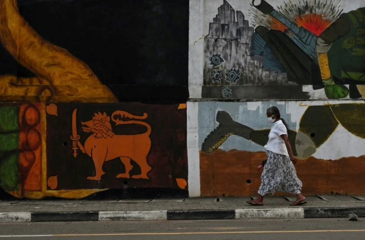 Une passante devant une fresque murale à Colombo, le 26 janvier 2021