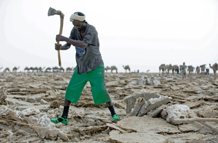 Un homme extraie du sel sur les bords du lac Assalé dans la région de la dépression du Danakil, le 28 mars 2017 à Afar, en Ethiopie