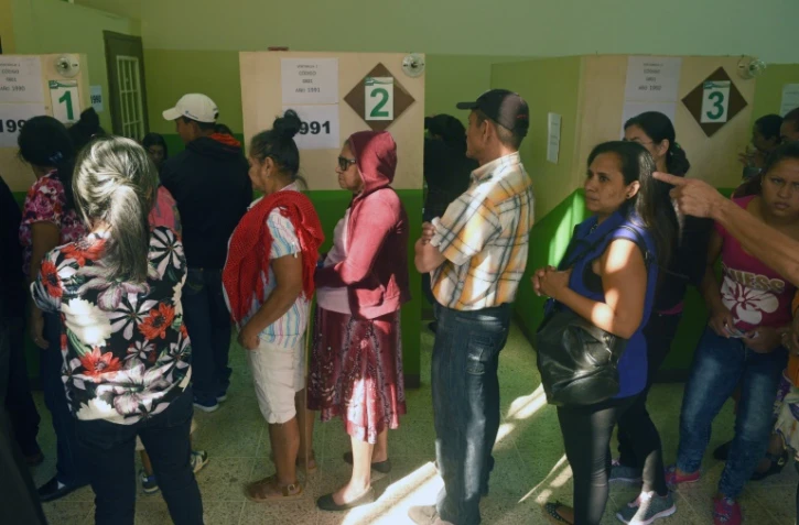 Des Honduriens attendent de recevoir leur carte d'électeur pour voter à la présidentielle, le 25 novembre 2017 à Tegucigalpa