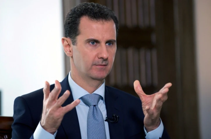 Photo fournie le 31 mars 2016 par l'agence de presse syrienne Sana du président Bachar al-Assad lors d'un entretien à l'agence de presse officielle russe Ria-Novosti à Damas