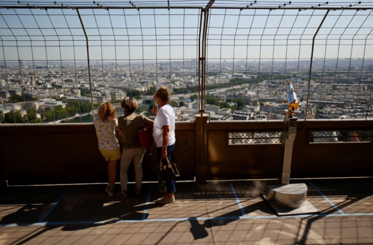 Des visiteurs regardent Paris d'un des deux premiers étages de la Tour Eiffel, le 25 juin 2020