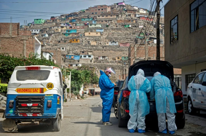 Des médecins se préparent pour aller voir un malade du Covid-19 le 11 juin 2020 près de Lima, au Pérou