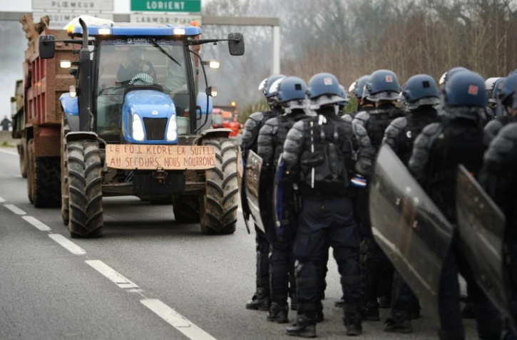 Des gendarmes français face à des agriculteurs en colère sur la RN165 bloquée près de Lorient, le 25 janvier 2016