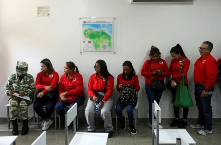 Des gens s'inscrivent pour rejoindre les forces militaires lors d'une campagne nationale d'enrôlement lancée par le président vénézuélien Nicolas Maduro, le 23 août 2025 à Caracas