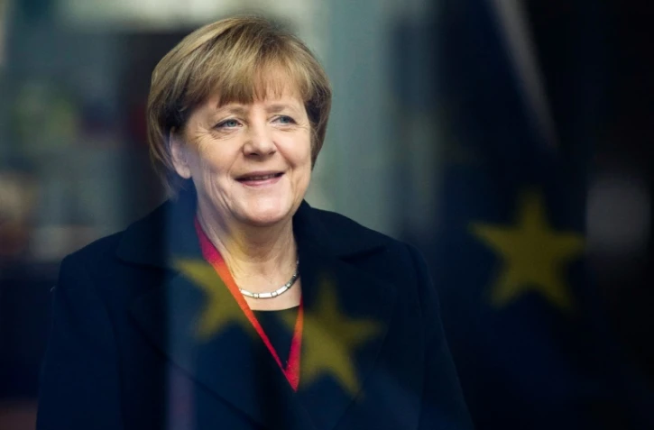 La chancellière Angela Merkel sourit face au reflet du drapeau européen le 13 novembre 2015 à Berlin