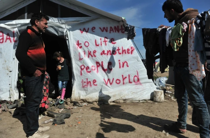 Des migrants dans le camp d'Idomeni en Grèce, le 26 mars 2016, à proximité de la frontière avec la Macédoine