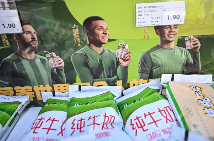 Affiche publicitaire de la marque de produits laitiers Mengniu mettant en scène les tars Lionel Messi, Kylian Mbappé et Lamine Yamal, le 28 octobre 2026 dans un supermarché de Pékin