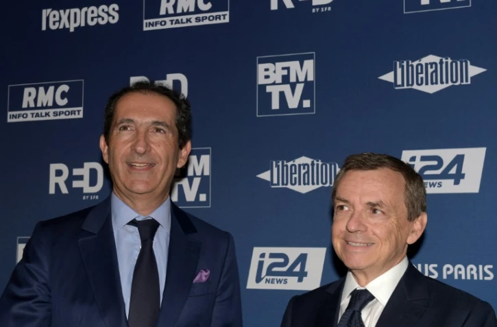 Le fondateur d'Altice Patrick Drahi (G) et le patron du groupe Altice Alain Weill le 9 octobre 2018 à Paris