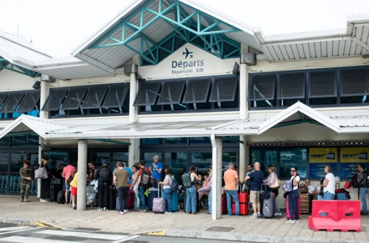 Des passagers attendent d'embarquer à l'aéroport de Magenta le 5 juin 2024 à Nouméa