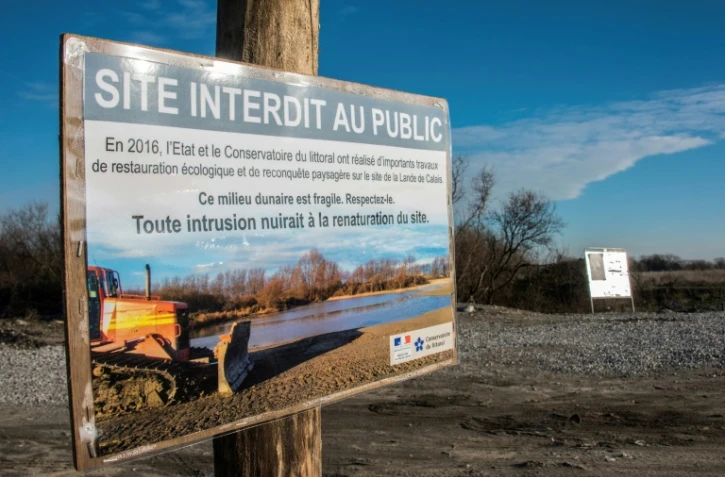 Un panneau "site interdit au public" à l'entrée de l'ancien camp de migrants de Calais, dit la "jungle", le 18 janvier 2017