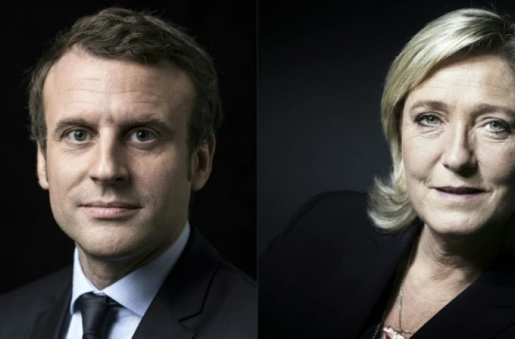 Emmanuel Macron (g) battrait largement Marine Le Pen (d) au second tour de l'élection présidentielle, selon deux sondages réalisés dimanche soir après l'annonce des résultats du 1er tour