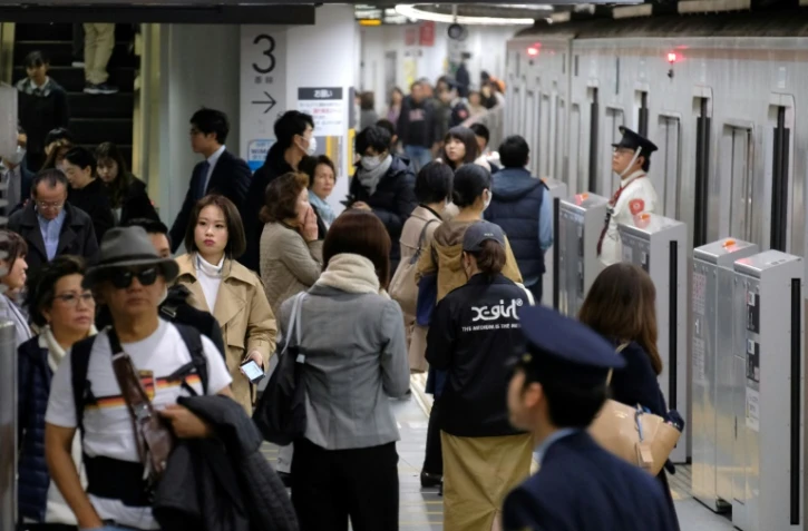 Des usagers du métro à la station Shibuya, le 1er mars 2018