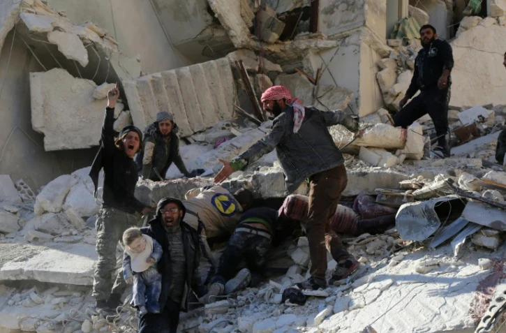 Des civils et des secouristes cherchent des victimes dans les décombres d'un bâtiment à la suite de frappes aériennes gouvernementales à Alep le 7 décembre 2015