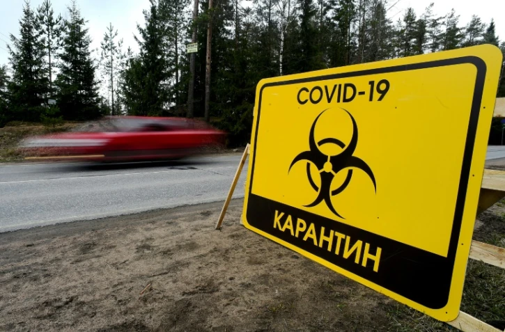 Un panneau d'avertissement "Quarantaine Covid-19" sur une route près de St-Pétersbourg, dans le nord-ouest de la Russie, le 3 mai 2020
