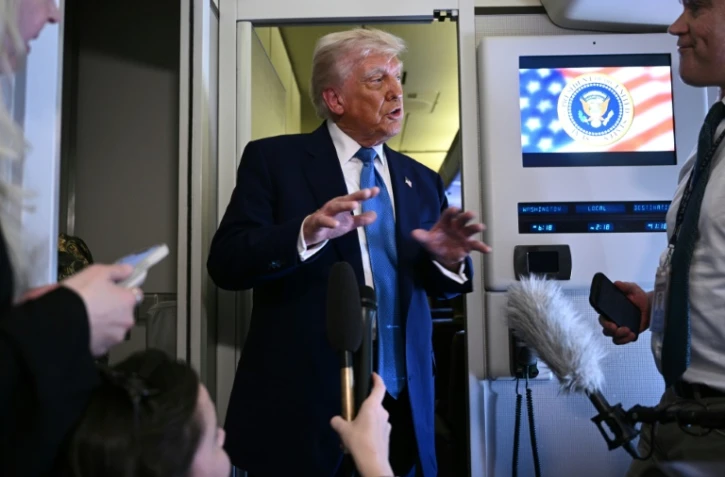 Le président américain Donald Trump s'adresse aux médias à bord d'Air Force One, après avoir quitté Abou Dhabi à l'issue de sa tournée au Moyen-Orient, le 16 mai 2025