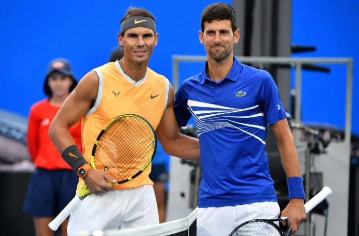 L'Espagnol Rafael Nadal (g) et le Serbe Novak Djokovic posent après la finale de l'Open d'Australie remportée par le Serbe, le 27 janvier 2019 à Melbourne 