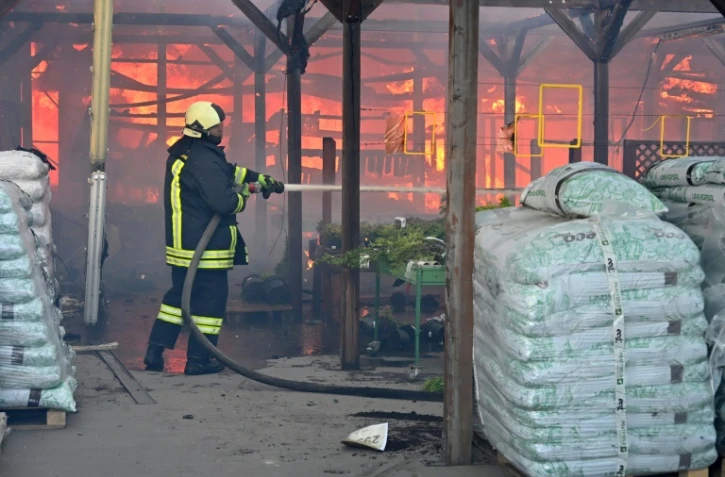 Un pompier ukrainien éteint un incendie dans un hypermarché après une frappe russe à Kharkiv, le 25 mai 2024