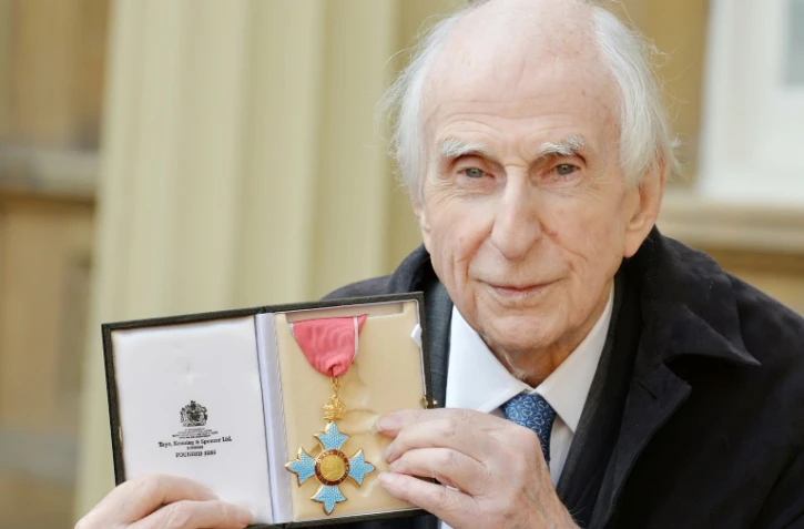 L'auteur britannique Michael Bond, qui a écrit la série de livres de Paddington Bear, pose avec sa médaille d'Officier de l'Ordre de l'Empire britannique au palais de Buckingham à Londres, le 27 octobre 2015