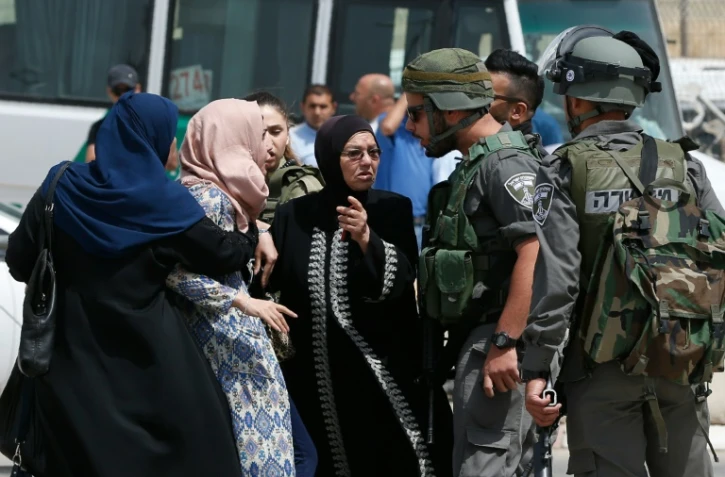 Palestiniens et soldats israéliens s'invectivent au point de passage de Qalandia, après la mort de deux Palestiniens, le 27 avril 2016