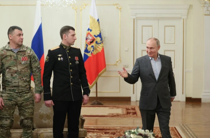 Photo transmise par l'agence officielle russe Sputnik montrant le président Vladimir Poutine lors d'une rencontre avec des militaires des forces armées russes, le 1er janvier 2024 à Novo-Ogaryovo, près de Moscou
