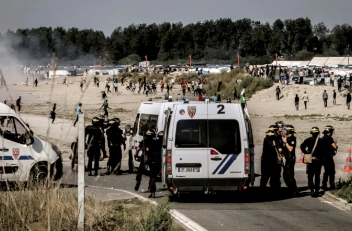 Des forces de police dispersent des migrants, qui tentaient de monter  à bord de camion, à Calais le 21 septembre 2016