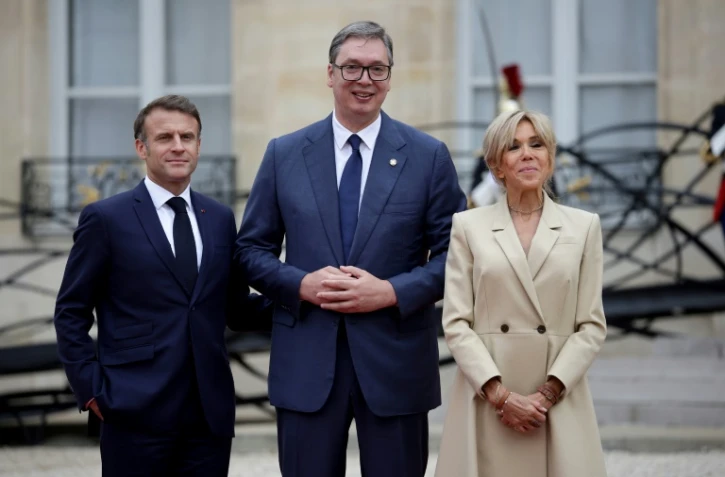 Emmanuel Macron (g) avec son homologue serbe Aleksandar Vucic (centre) et son épouse Brigitte Macron (d) au Palais de l'Elysée à Paris le 26 juillet 2024