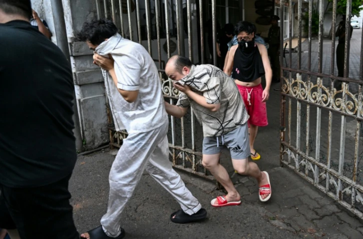 Des ressortissants chinois suspectés d'appartenir à un réseau de cybercriminalité sont escortés vers une prison sri-lankaise après leur arrestation à Colombo, le 9 mai 2026
