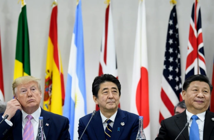 Le président américain, Donald Trump, le Premier ministre japonais, Shinzo Abe, et le président chinois, Xi Jinping, au sommet du G20 à Osaka le 28 juin 2019