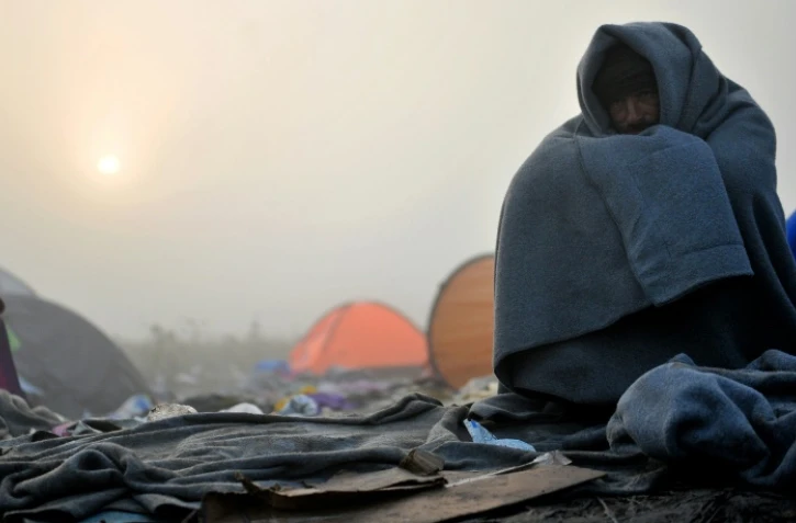 Un migrant tente de se réchauffer, à Berkasovo, près de la ville serbe de Sid à la frontière serbo-croate, le 24 octobre 2015