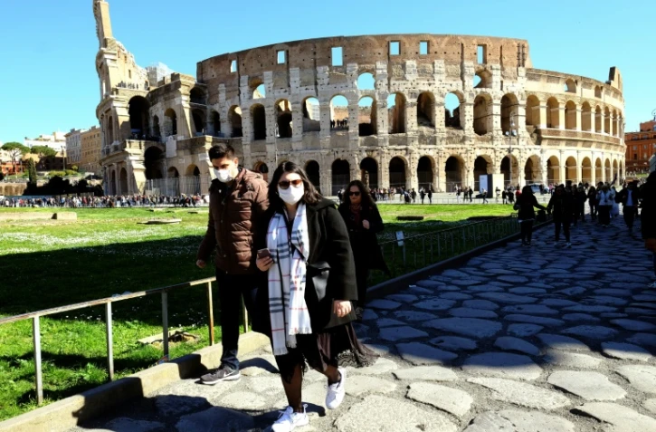 Des touristes se promenant près du Colisée à Rome, avec des masques pour se protéger du nouveau coronavirus, le 28 février 2020.