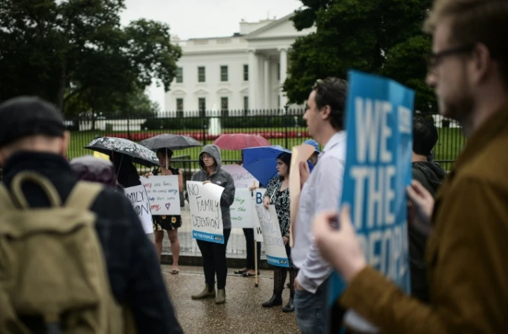 Des manifestants devant la Maison Blanche à l'appel de l'association pour les libertés civiles ACLU pour protester contre la séparation des familles à la frontière américano-mexicaine, le 22 juin 2018