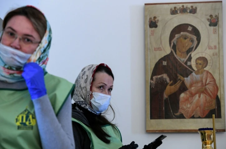 Des fidèles masquées assistent à la traditionnelle bénédiction à Moscou, le 18 avril 2020, à la veille de la Pâque orthodoxe