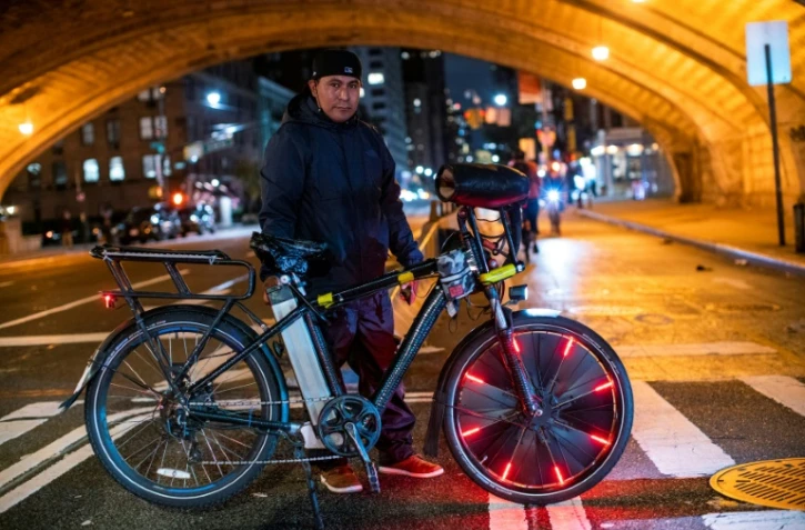 Un livreur mexicain, Vicente Carrasco, membre du groupe "Delivery Boys United", pose, le 27 octobre 2021, alors qu'il monte la garde avec certains de ses collègues à Manhattan, à New York, contre les vols de vélos