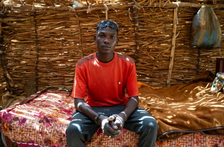 Un réfugié soudanais âgé de 24 ans, Albakir Abbas Ishag, dans son abri de fortune dans un camp à Koufroun, au Tchad le 9 avril 2024