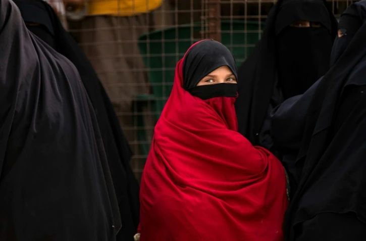 Une enfant attend devant une grille avec des femmes retenues dans le camp Al-Hol, dans le nord-est de la Syrie, où s'entassent des milliers de familles de combattants présumés du groupe Etat islamique, pour beaucoup étrangers, le 11 octobre 2023